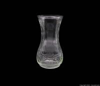 Full view of clear ribbed glass vase showing shape and rib pattern