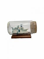 Bottle side view showing origami ship and cork
