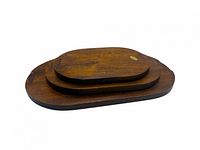 Three stacked teak nesting charcuterie boards top view