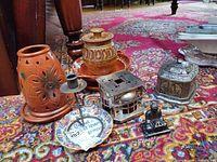 Group shot of all ceramic and metal decor pieces on rug