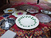 Overview of ceramic plates, holly bowl, glass platter and stainless divided dish