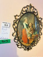 Framed oval print in ornate metal frame, size tag visible