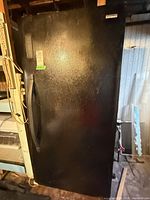 Full view of black Kenmore upright freezer front with handle