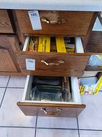 Drawer view showing packaged food storage consumables and glass baking dishes