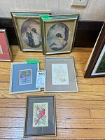 Overall view of the five framed artworks on floor