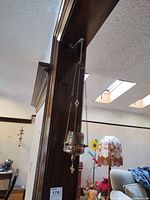 Full view of one candle holder hanging to show scale and complete length