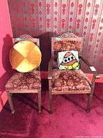 pair of armchairs with both pillows in place