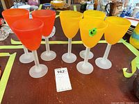 All seven frosted wine glasses grouped on table