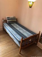 Full view of assembled twin bed with mattress and box spring