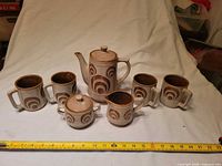 Full set displayed with tape measure for scale