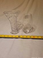 Both crystal vases beside ruler showing height