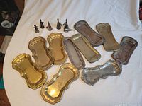 Overview of all trays and snuffers on white cloth