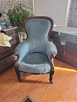 Front view of balloon back armchair showing upholstery and wood frame