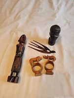 Group shot of all five carved wooden items on white background