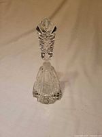 Full view of faceted cut-glass perfume bottle with stopper inserted
