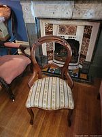 Front view of Victorian balloon back chair showing upholstery and wood frame