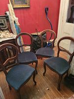 Four balloon back chairs grouped on hardwood floor