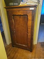 Front view of wardrobe showing veneered door, moulding and missing escutcheon