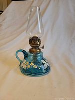 Full view of blue glass oil lamp with chimney