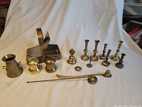 Group shot of all 15 brass items on white backdrop
