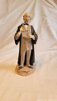Front view of Capodimonte porcelain lawyer figurine holding document marked BRIEF
