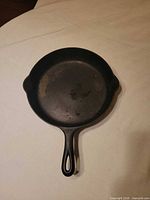 Top view of Griswold No.9 cast iron skillet showing cooking surface and handle