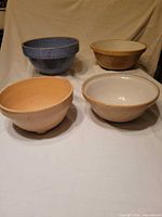 Four ceramic mixing bowls grouped together