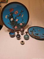 Group view of both chargers, three vases, bowl and pot