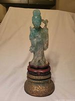 Full view of jadeite goddess statue on wood and brass base