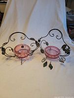 Both cranberry glass dishes mounted in vine holders, overall view
