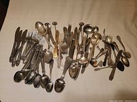 overview of entire mixed cutlery lot spread on surface