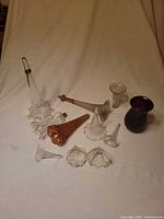 Group shot of all 11 glass trumpets displayed on cloth