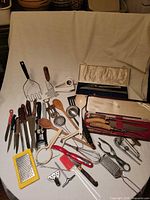Overall view of mixed kitchen tools spread on table