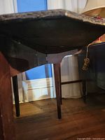 Underside view showing folded leaf and wooden swing support