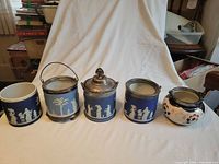 Five of the six biscuit barrels front view