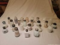 Front aerial view of all 25 single shakers on cloth backdrop