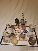 Overall view of tray showing assortment of ceramic, glass, stone and metal parts