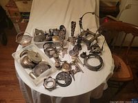Overview of entire lot on table showing mixed metal parts
