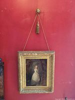 Framed oil painting hanging on wall