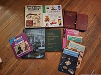 Front covers of all 11 books arranged on wood floor