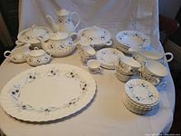 Full set overview showing cups, bowls, plates, platter, serving pieces