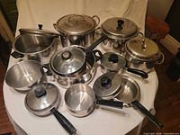 Group shot of all stainless steel pots, pans and bowl on table