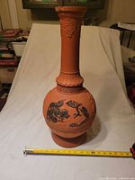 Front view of terracotta vase with relief dragons