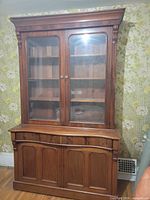 Front view showing complete bookcase with upper glass doors and lower paneled doors