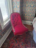 Front view of red velvet Victorian nursing chair by window