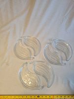 Top view of three clear glass plates showing bell-pepper shape and ridged design