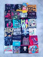 All 25 folded graphic tees laid out in 5x5 grid