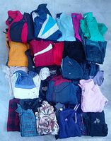 Stack of assorted jackets and vests showing range of colors and styles