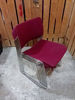 single chair angled view showing chrome rod frame and burgundy upholstery