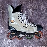 Side view of right skate showing boot, chassis and wheels